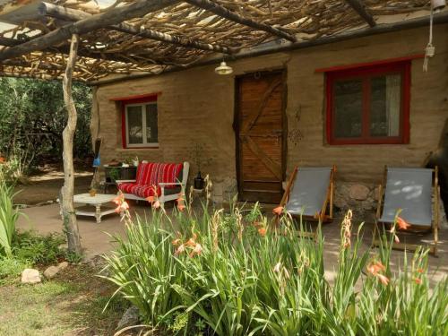 a house with two chairs and a table and a patio at El Rancho Eco Loft in San Javier