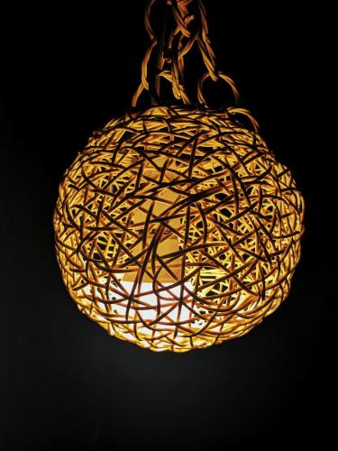 a close up of a light fixture with a sphere at Moon Bay in Mirissa