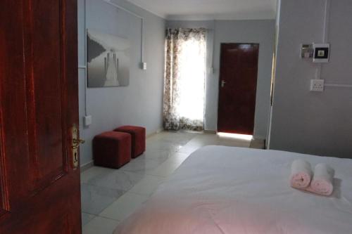 a bedroom with a bed with two towels on it at 54 River Logde in Mokopane