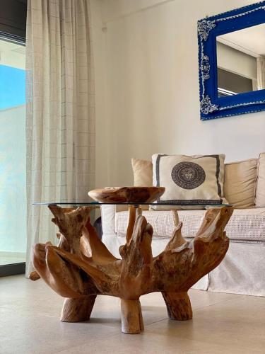 a wooden tree stump coffee table in a living room at MiLiON RESIDENCES in Parga