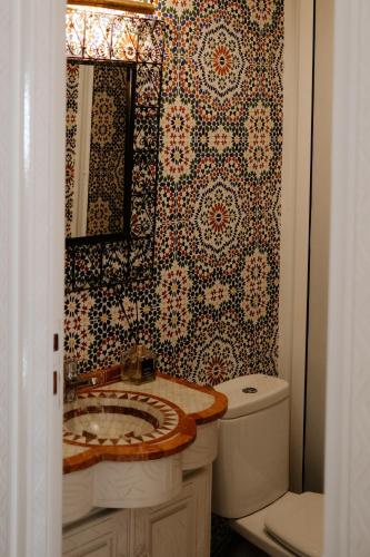 a bathroom with a sink and a toilet at Riad Searenity in Tamraght Ouzdar