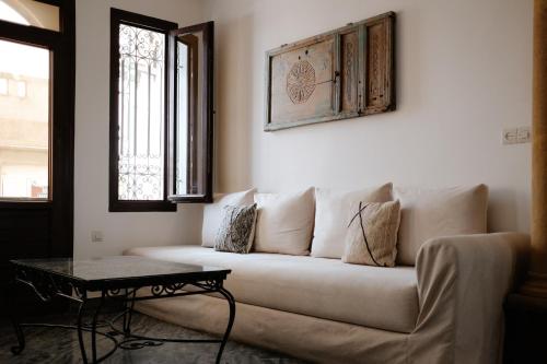 a living room with a couch and a table at Riad Searenity in Tamraght Ouzdar