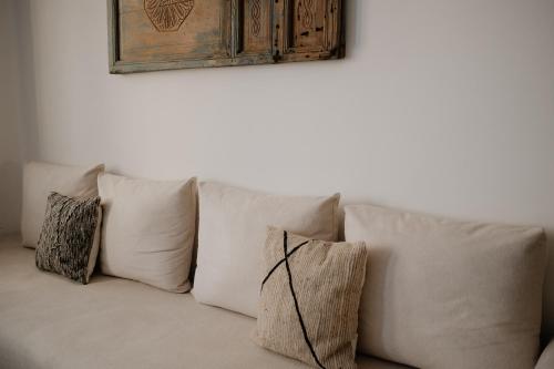 a bunch of pillows sitting on a couch at Riad Searenity in Tamraght Ouzdar