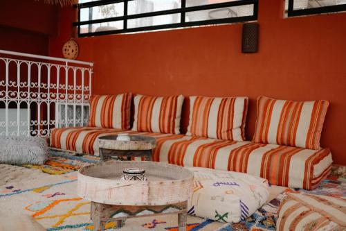 a living room with a couch and a table at Riad Searenity in Tamraght Ouzdar