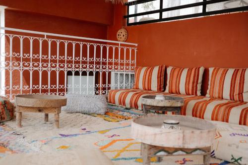 a living room with a couch and a table at Riad Searenity in Tamraght Ouzdar