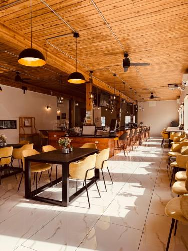 a dining room with tables and chairs and wooden ceilings at The Hotel Pendleton, Trademark Collection by Wyndham in Pendleton