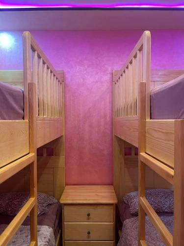 two bunk beds in a room with purple walls at Al Hoceima Hay Bades Villa in Al Hoceïma