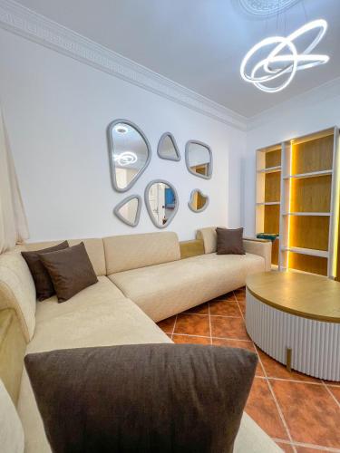 a living room with a couch and a table at Appart-Hôtel Costa Azul - Bilal in Tetouan