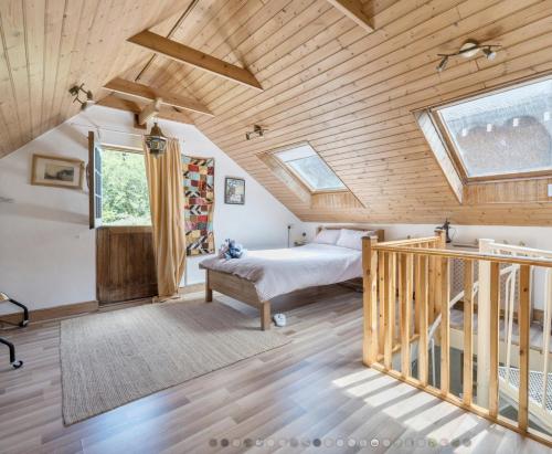 a bedroom with a bed and a wooden ceiling at The Art Apartment in Coulsdon