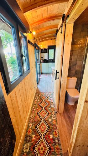 a bathroom with a toilet and a rug at The Green Wagon Costa Brava, Piscina Privada, AC, WIFI, Parking, Terraza in Tordera