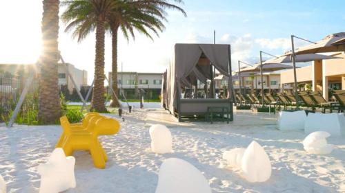 a beach with chairs and a yellow object in the sand at Beautiful Home W 3 En Suites & Breathtaking View in Orlando
