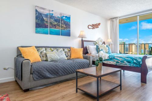 a living room with a couch and a table at Renovated Condo Near Waikiki Beach in Honolulu