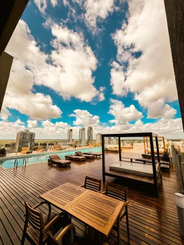 a deck with a picnic table and a view of the city at Los Silos Hotel in Santa Fe