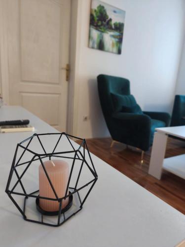 a candle on a table in a living room at Stan na dan Dašnica in Bijeljina