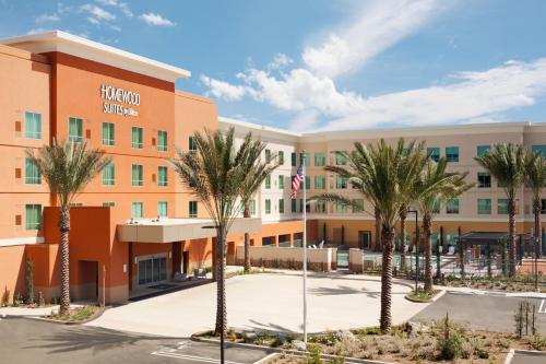 an image of a hotel with palm trees in front at Homewood Suites By Hilton Irvine John Wayne Airport in Irvine