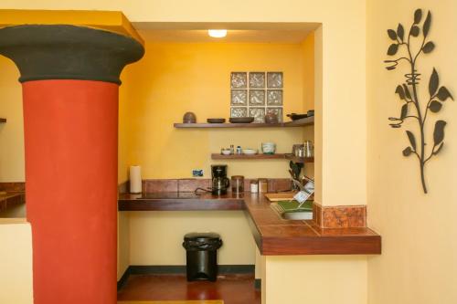 a kitchen with a red column in a room at Lake Arenal Hotel & Brewery in Tilarán