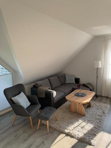 a living room with a couch and a table and chairs at Schöne Ferienwohnung am Waldrand in Detmold