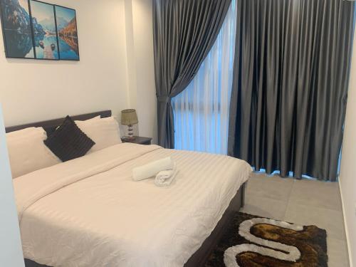 a bedroom with a white bed with a large window at Nova luxe 2 Bed Executive Stay in Accra