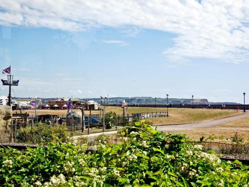a view of a field with a fence and a road at Brunel Boutique Railway Carriage 5 in Dawlish Warren