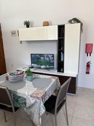 a dining table with a laptop computer on a desk at Cosy 2 Bedroom Penthouse with Terraces & seaview in St Paul's Bay