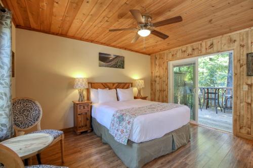 a bedroom with a bed and a ceiling fan at Fernwood Resort in Big Sur