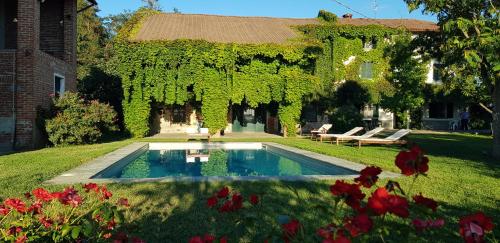 a swimming pool in the yard of a house at Cascina Coccione in Predosa