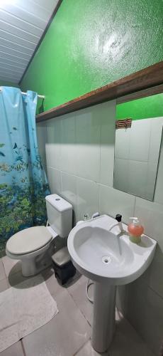 a bathroom with a white toilet and a sink at Espaço Sairé - 8 minutos da Praia in Alter do Chao