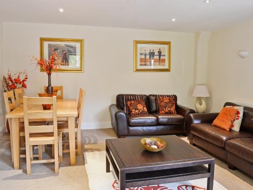 a living room with a couch and a table at Fenn House in Alvechurch