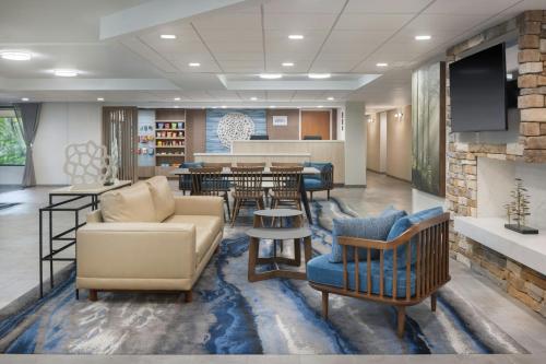 a waiting room with couches and chairs and a bar at Fairfield by Marriott Mission Viejo Orange County in Mission Viejo