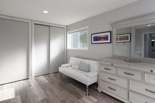 a living room with a white dresser and a chair at Ocean Aire in Bandon