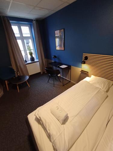 a hotel room with a bed and a window at Room 3 in the center of Saeby with free parking in Sæby