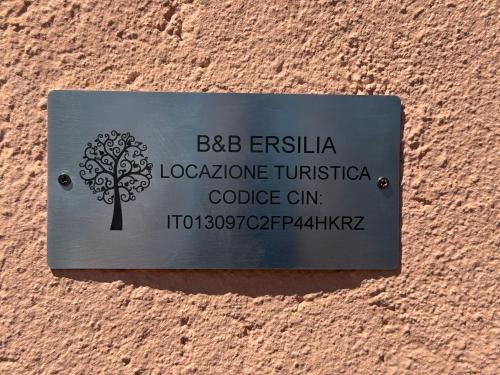 a sign on a wall with a tree on it at B&B Ersilia in Eupilio