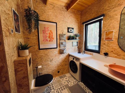 a bathroom with a sink and a washing machine at chillas - dom nad jeziorem Chańcza in Korytnica
