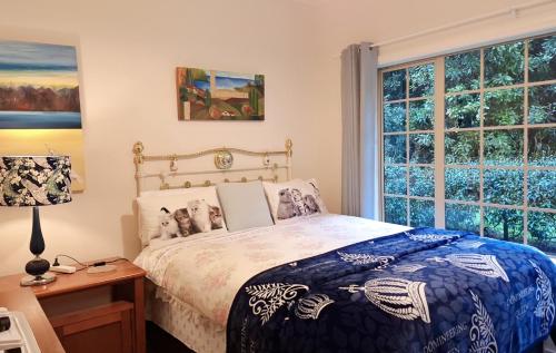 a bedroom with a bed and a window at NZ County Holiday Home in Kamo