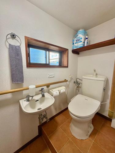 a bathroom with a toilet and a sink at Hav Living in Oshima