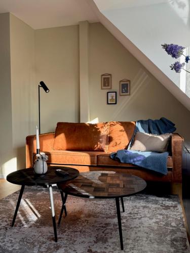 a living room with a couch and a table at Emils City Suite in Vreden