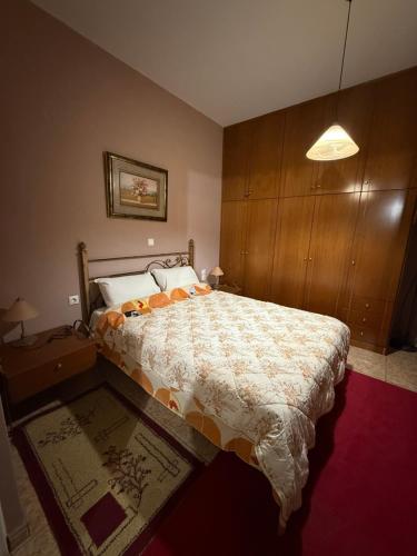 a bedroom with a bed and a wooden cabinet at Modern 1-bedroom with BBQ & Roof Garden near Beach in Stalos