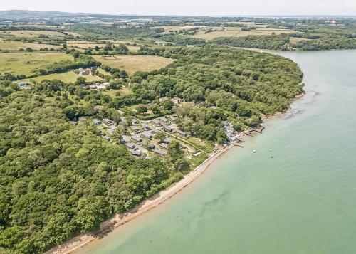 an aerial view of a beach with houses and trees at Woodside Coastal Retreat in Ryde