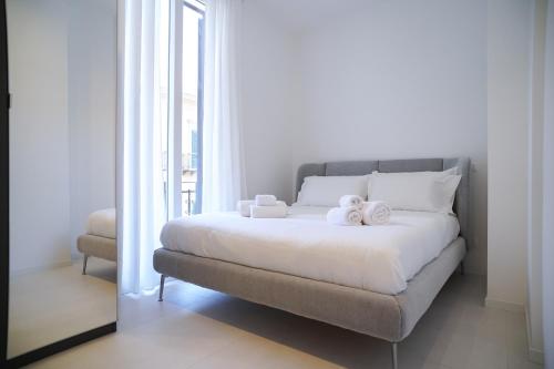 a bedroom with a bed with two towels on it at Mama suites Politeama in Palermo