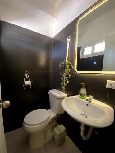 a bathroom with a white toilet and a sink at El Yaque Flow Beach, tu apartamento de playa in El Yaque