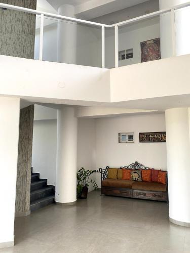 a living room with a loft with a couch and stairs at El Yaque Flow Beach, tu apartamento de playa in El Yaque
