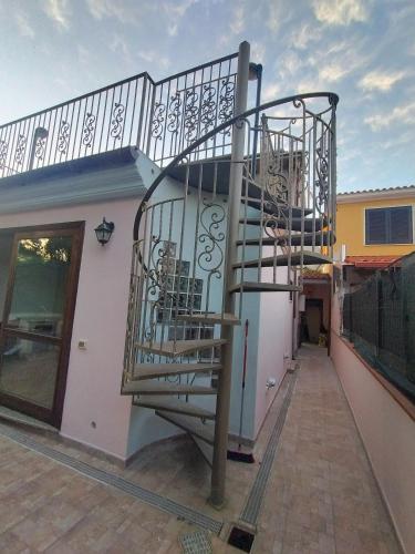 a spiral staircase on the side of a building at Villa Sonia in Maddalenedda
