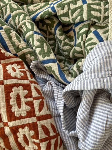 a close up of a blanket with patterns on it at Auberge du Jardin in Petit-Saguenay