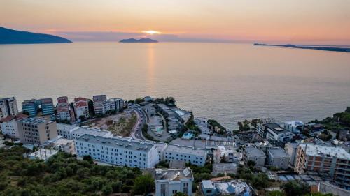 an aerial view of a city by the water at sunset at Hotel Ble Ble Vlore in Vlorë
