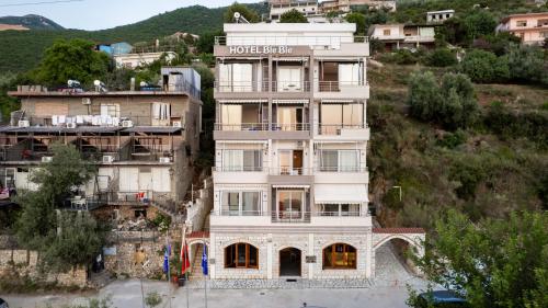 a building on the side of a hill at Hotel Ble Ble Vlore in Vlorë