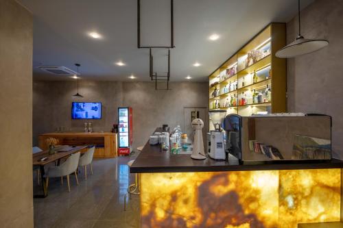 a kitchen with a counter and a table with chairs at Hotel Ble Ble Vlore in Vlorë