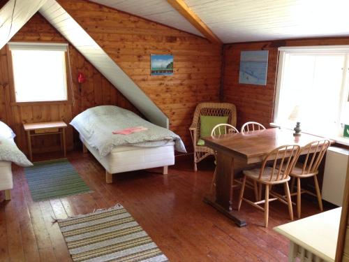 a bedroom with a bed and a table in a room at Marston Hill in Mullsjö