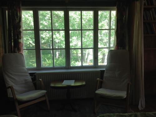 two chairs and a table in front of a window at Marston Hill in Mullsjö
