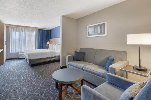 a hotel room with a couch and a bed at Best Western Eau Claire South in Eau Claire