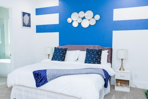 a blue and white bedroom with a large bed at Cozy and Chic 3BR Retreat in Downtown Houston in Houston